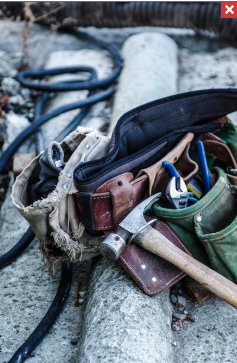 Handyman tool belt with hammer and other common tools for household repairs and improvement projects